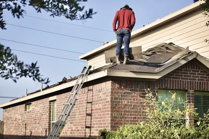 Professional roofer working on a residential roof in Old North Durham